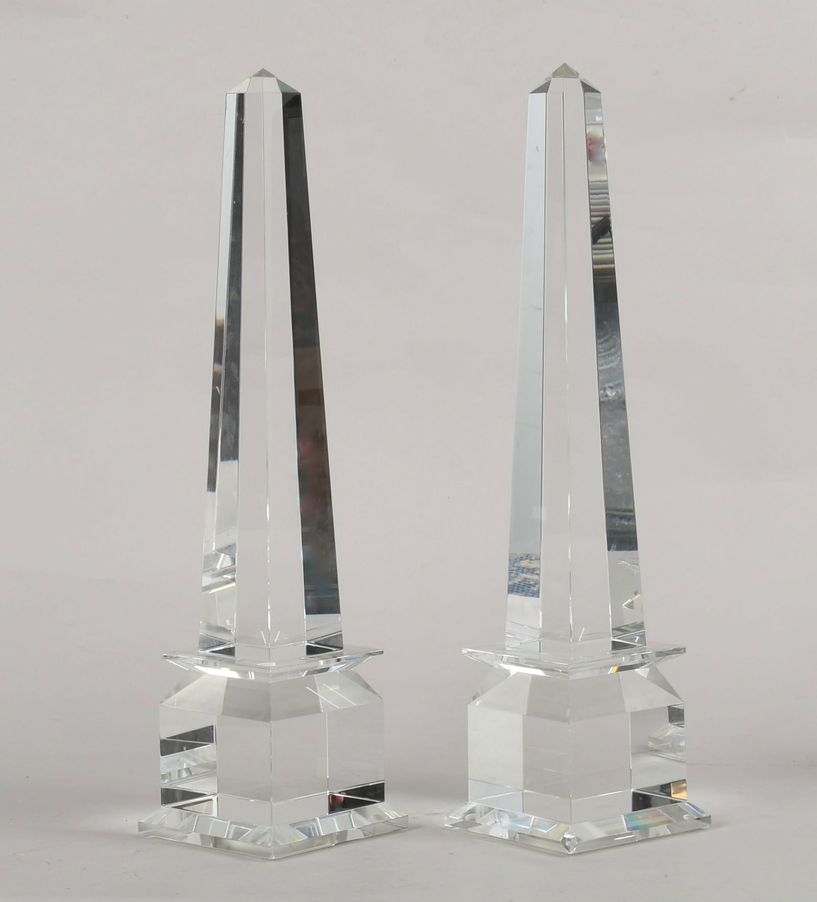 A Pair of Crystal Obelisks: A Pair of Crystal Obelisks Contemporary, with Veritas mark at the bottom. Dimensions: each stand 22 1/2" tall, the bases are 5 1/2" x 5 1/2"