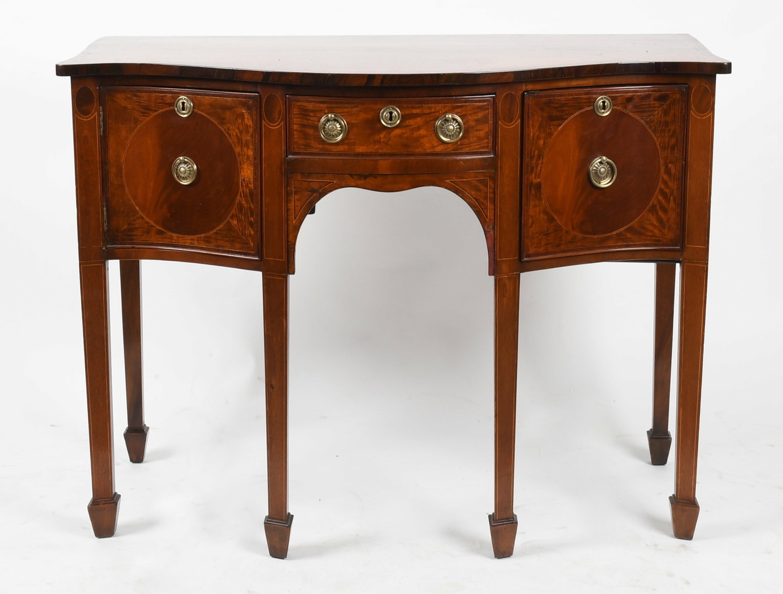 George III Inlaid Mahogany Sideboard, Circa 1800: A George III Inlaid Mahogany Sideboard, Circa 1800 The rectangular string inlaid top with serpentine front over one short central drawer, flanked by a single cupboard to the left and deep drawer to th