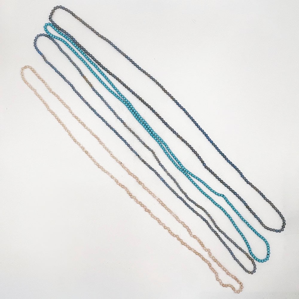 Large Grouping of Stone Beaded Necklaces: This lot includes Garnet, Chalcedony, Turquoise, Bone, Unakite, Quartz, Lapis, Malachite, Carnelian and agate stones. Necklaces measure from 18 to 36 inches long. The beads range in size from 4mm to 2