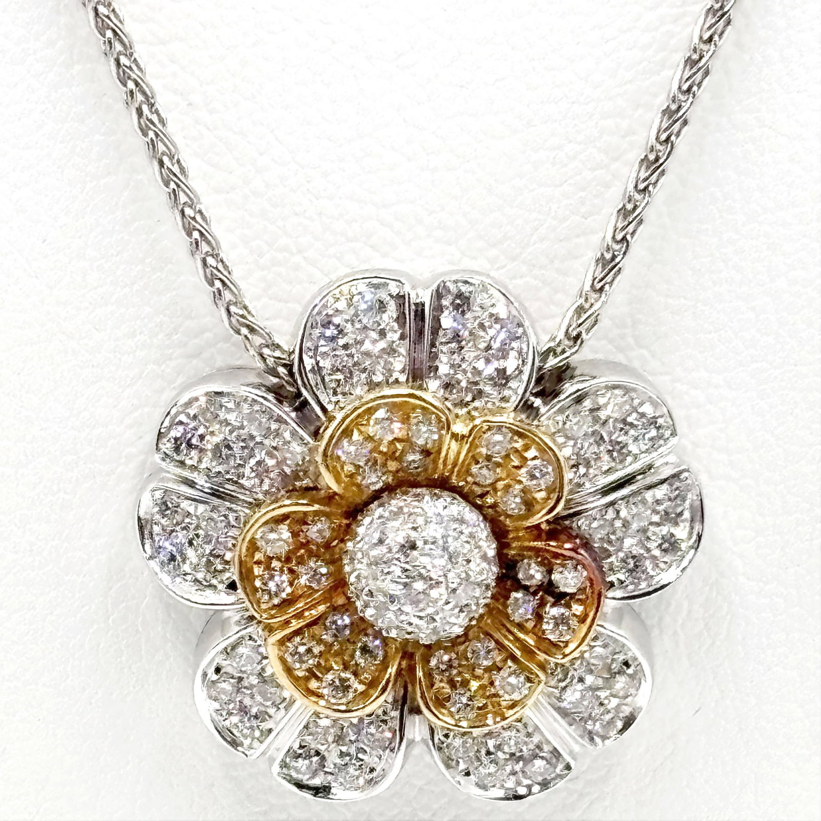 18K Yellow and White Gold Flower Necklace: 18K Yellow and White Gold Flower Necklace. The pendant is set with ninety-seven diamonds, with a total weight of 1.50ct. Measuring 17inches in length, the pendant measures 1x1inch Gross weight 10.4dwt