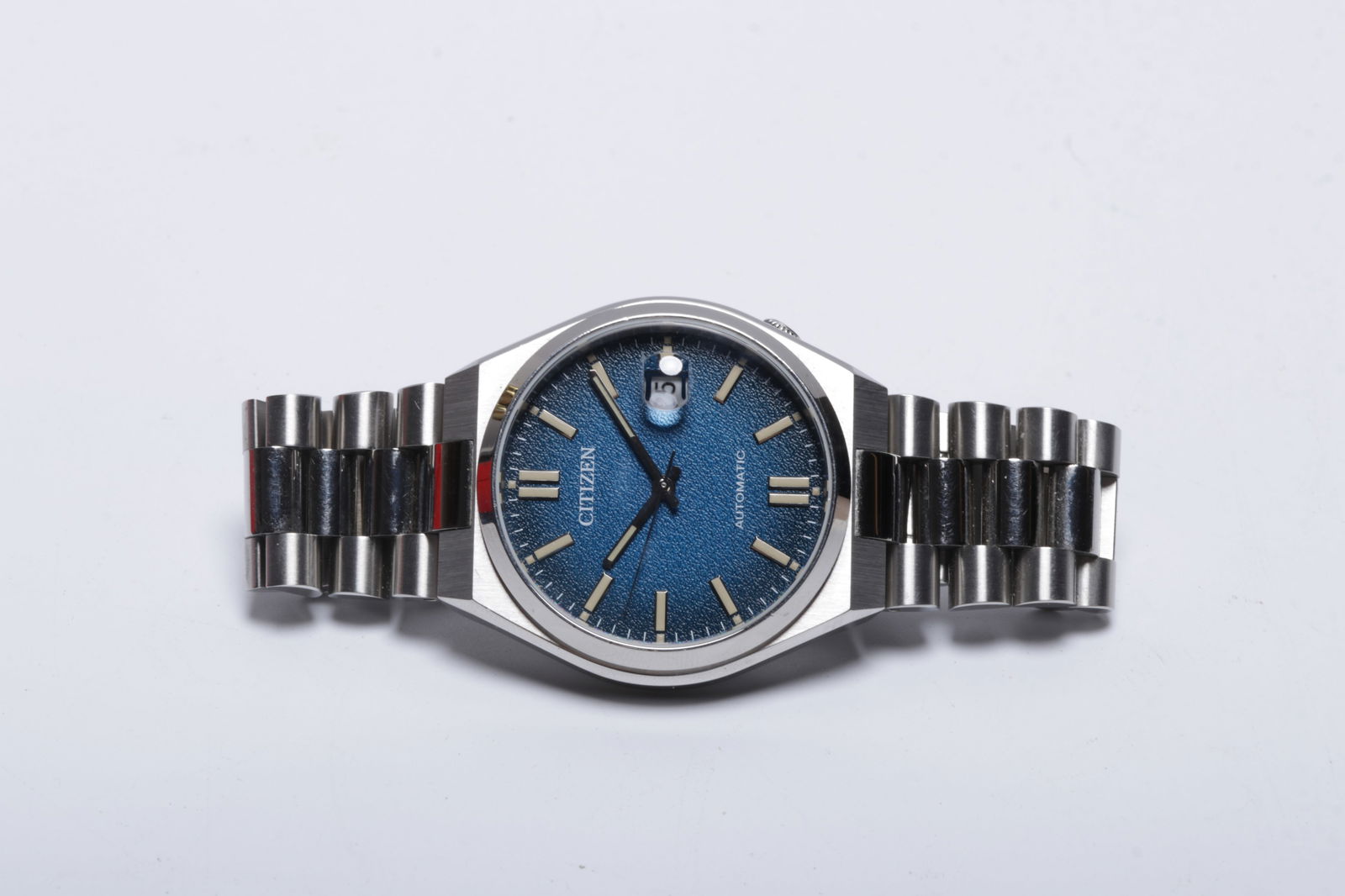 A Citizen "Tsuyosa" Integrated Bracelet Wristwatch: A Citizen "Tsuyosa" Integrated Bracelet Wristwatch A modern Citizen automatic stainless steel wristwatch with a textured sunburst dial, date window, cyclops and applique lumed ind