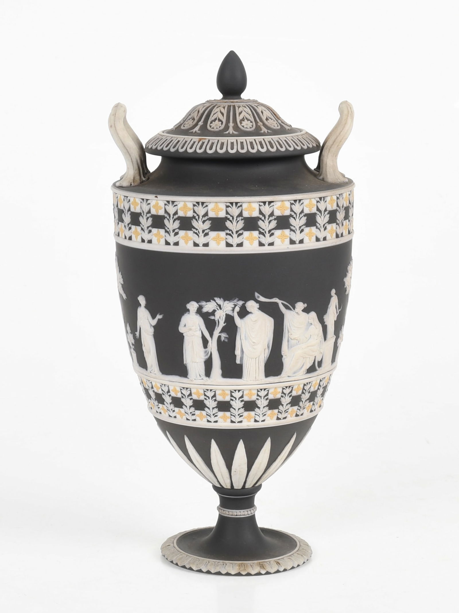 A Wedgwood Black Jasper Dip Covered Urn, Tricolor: A Wedgwood Black Jasper Dip Covered Urn, Tricolor Early 19th century, in black (dark grey), white, and yellow, the central figural scenes bordered with dice motif, arabesques, and other classica