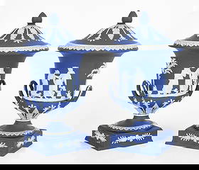 A Pair of Wedgwood Jasper Dip Covered Urns: A Pair of Wedgwood Jasper Dip Covered Urns 20th century, a pair of covered urns in royal blue with the typical decoration of classical figures, acanthus, garlands, and imbricated leaf borders.&n