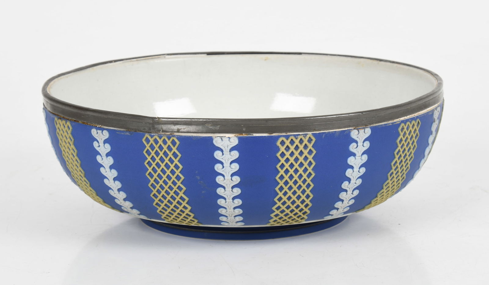 A Wedgwood Tricolor Jasper Dip Salad Bowl: A Wedgwood Tricolor Jasper Dip Salad Bowl c. 1882, in royal blue, white, and yellow, a salad bowl with metal rim liner and geometric and imbricated pattern decoration. Dimensions: height is