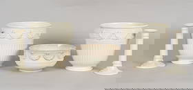 A Group of Wedgwood Queensware: A Group of Wedgwood Queensware 19th and early 20th centuries, comprising: a pair of fluted jardinieres with rams head and festoon decoration, a serving bowl with similar decoration and