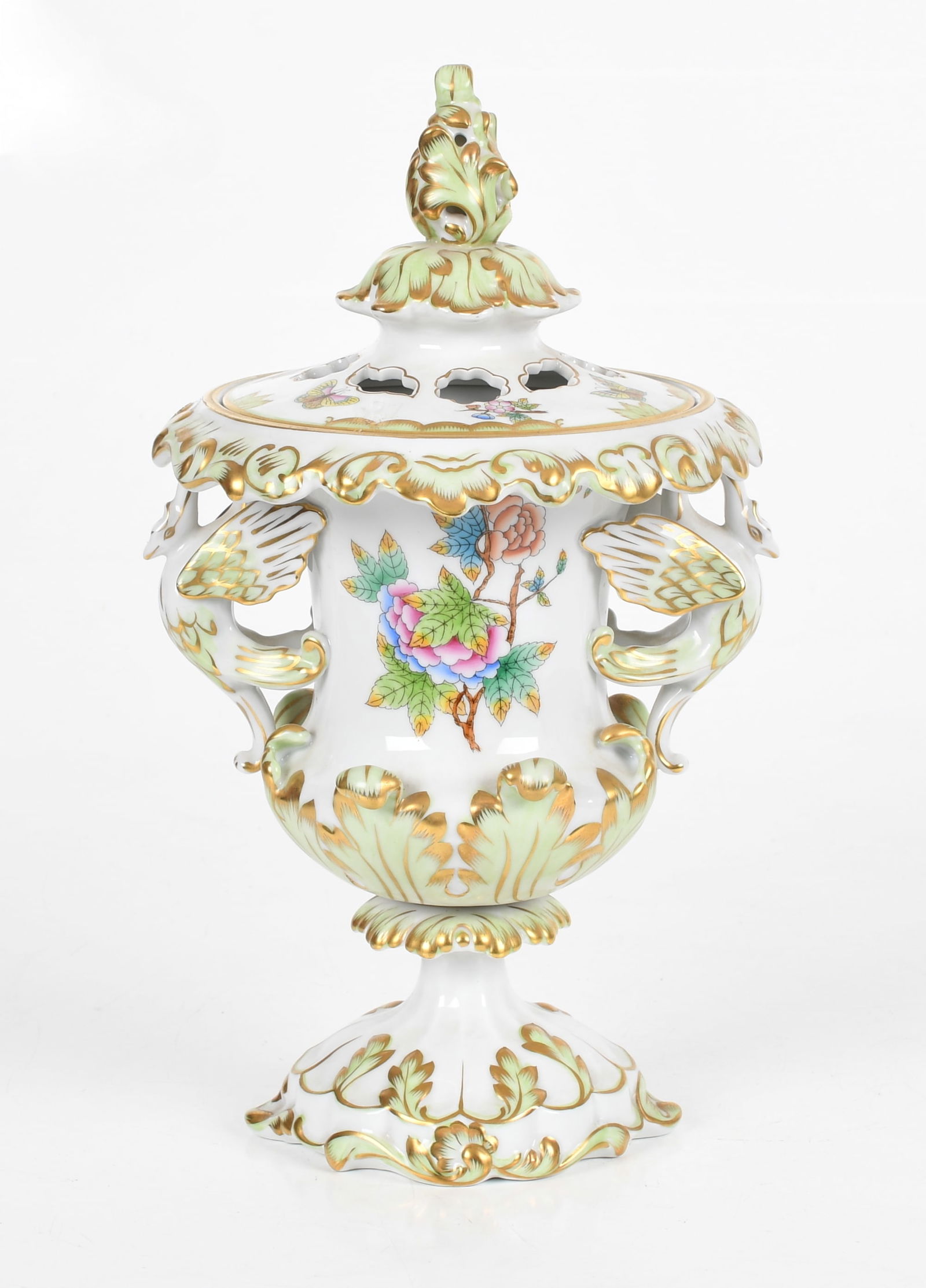 A Herend Lidded Urn, Queen Victoria: A Herend Queen Victoria Lidded Urn The urn on a pedestal base with swan handles, the lid is pierced with foliate and floral motifs, marked as pictured at the bottom. Dimensions:&