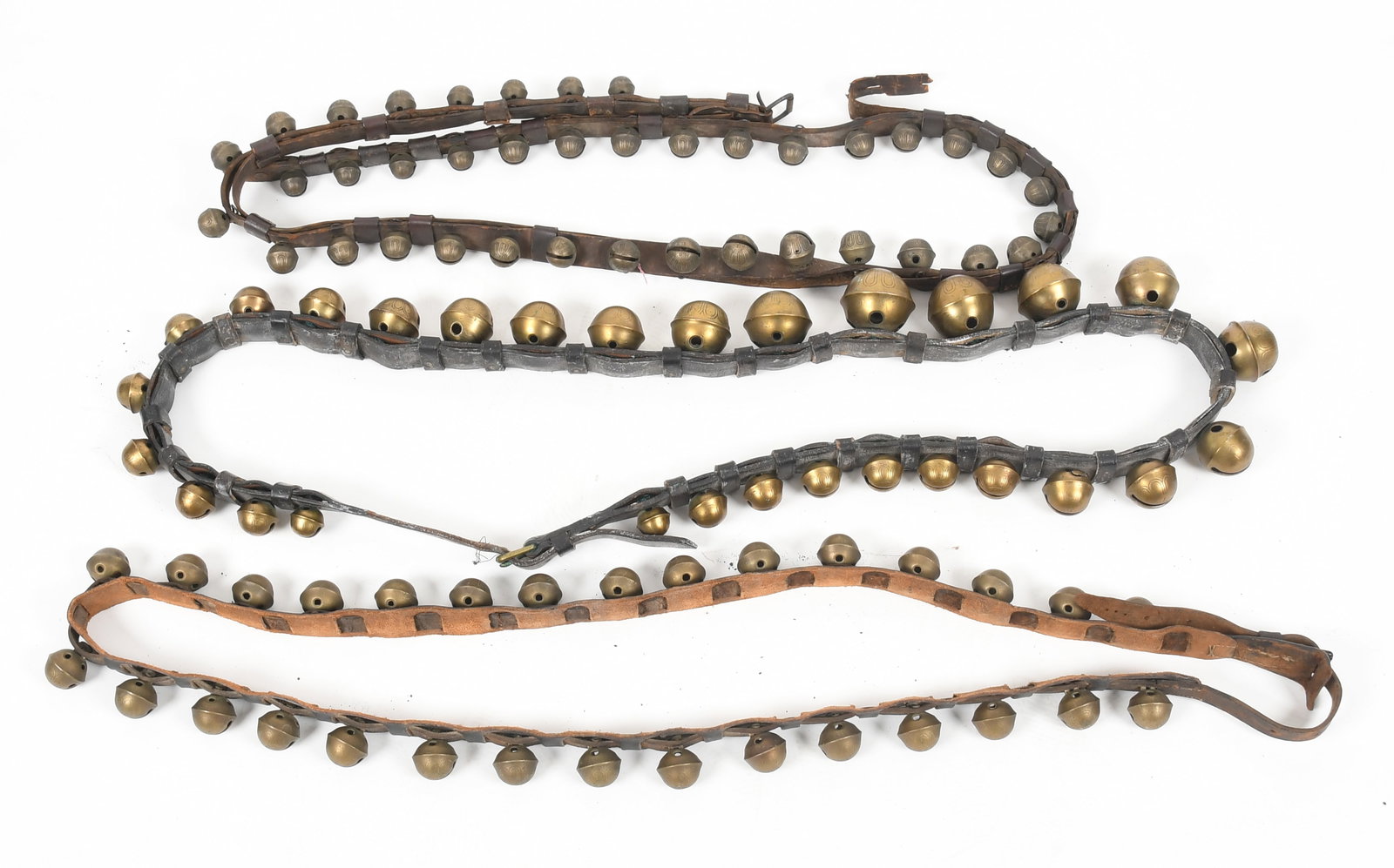 Three Straps of Brass Petal Incised Sleigh Bells, 19th Century: A Strap of Twenty-Nine Cast Brass Petal Incised Sleigh Bells, Second Half 19th Century Comprising two 'No. 1' bells; ten 'No. 4' bells; two 'No. 5' bells; two 'No. 6&#