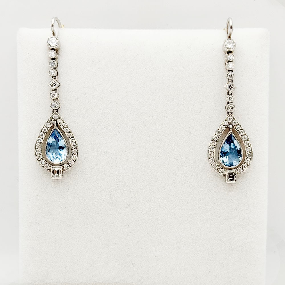 Platinum Diamond and Aquamarine Earrings: Platinum Diamond and Aquamarine Earrings A pair of Platinum and gold aquamarine and diamond earrings. Each earring is set with twenty-nine diamonds, a total weight of 1.00cts. The aquamarines h