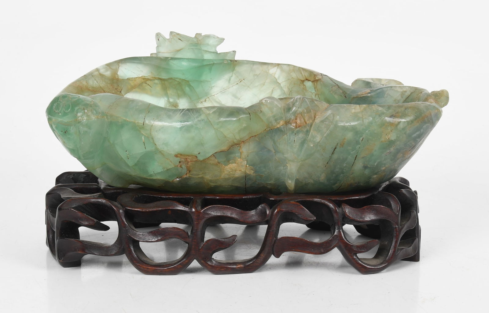 A Chinese Green Quartz Brush Washer: A Chinese Green Quartz Brush Washer A lotus carved example with custom wooden stand. Dimensions: 12in x 8in, the overall height on the stand is 5 3/4in. 