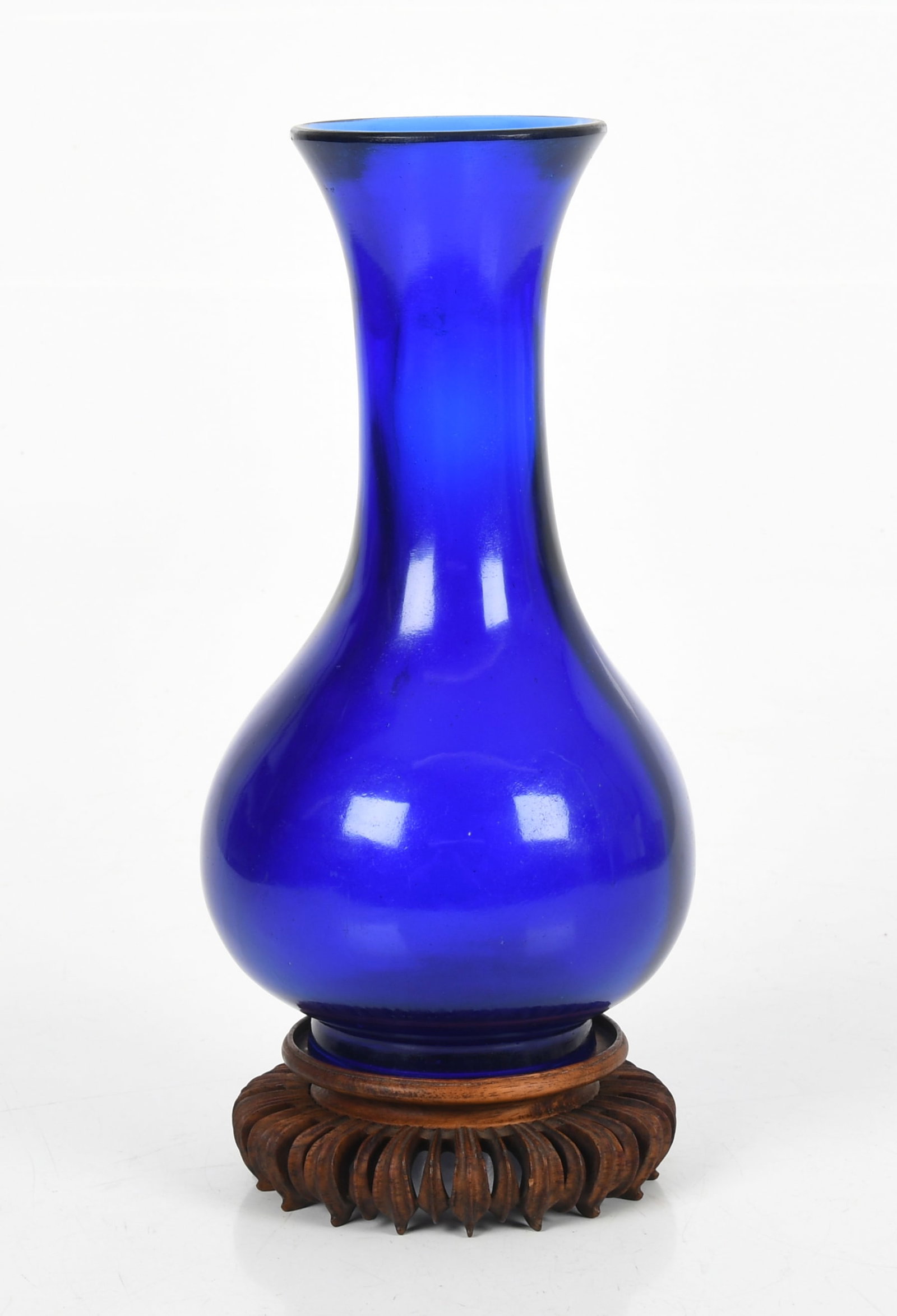 A Chinese Cobalt Blue Peking Glass Baluster Vase, 19th Century: A Chinese Cobalt Blue Peking Glass Baluster Vase, 19th Century Of elegant form, with etched signature on underside of footed base; raised on a carved lotus-form stand. Dimensions: 10 1/4
