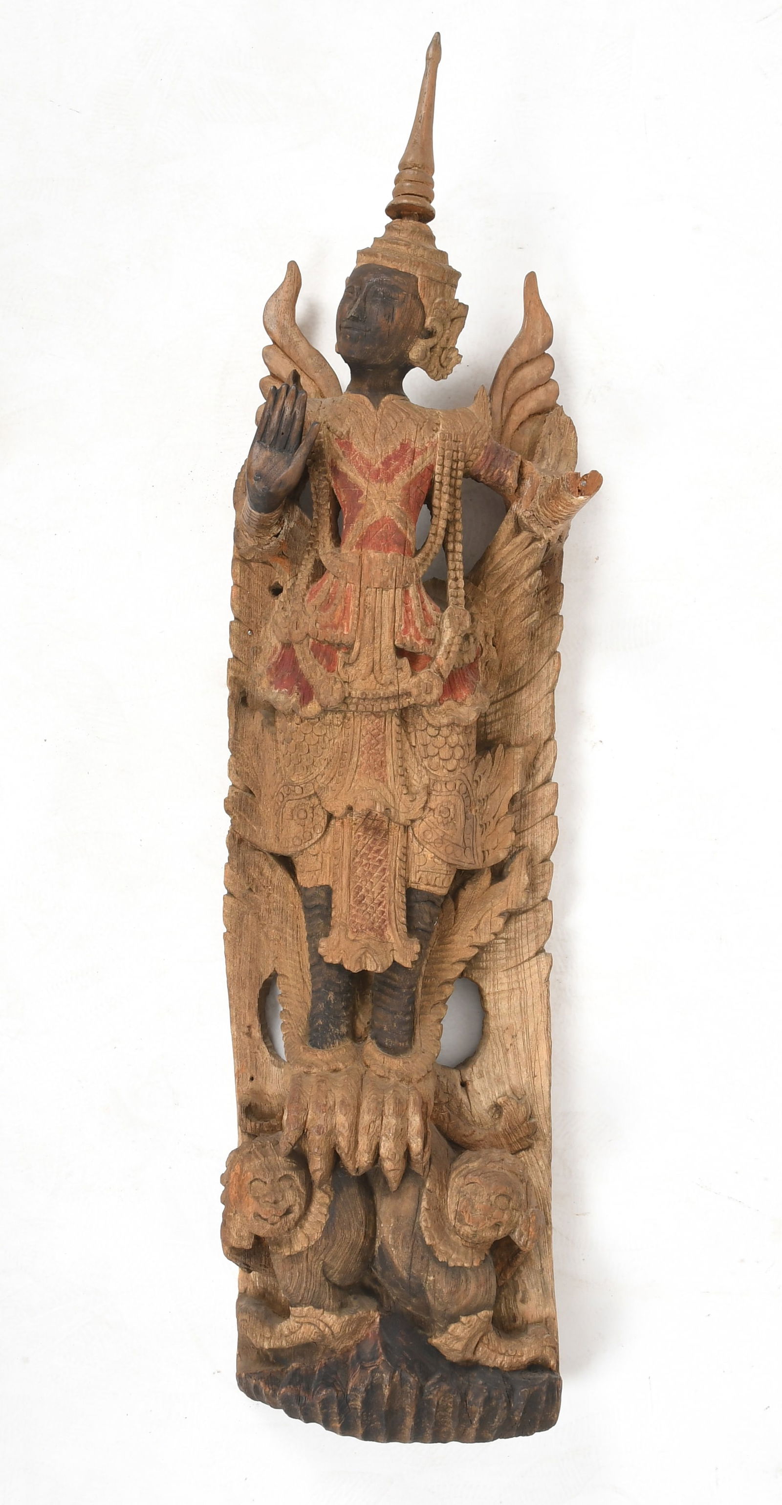A Large Carved Wood and Polychrome Thai Carving: A Large Carved Wood and Polychrome Thai Carving 20th century, depicting a figure standing upon two beasts. Dimensions: 43in x 12in x 7in. 