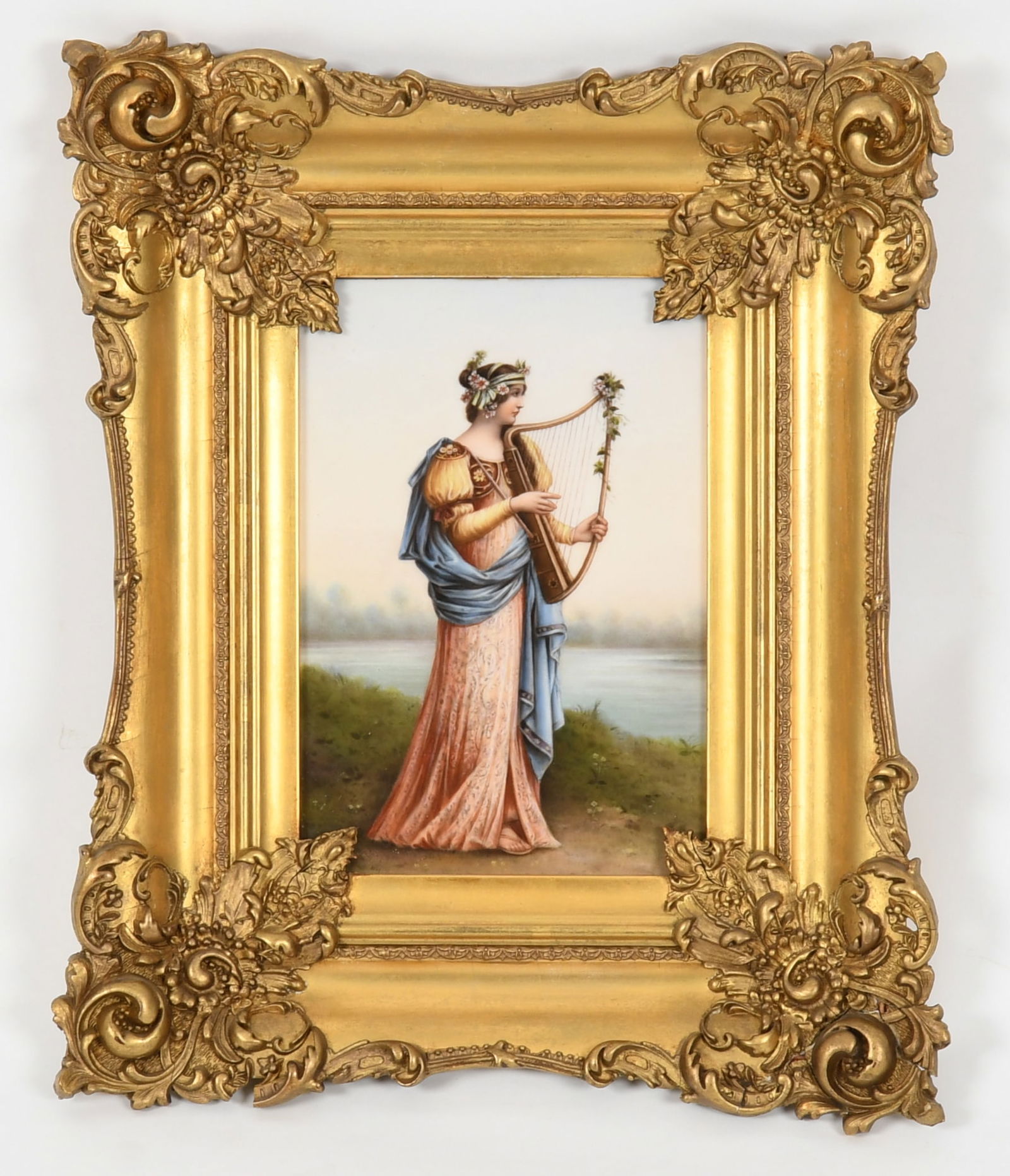 A German KPM-Style Porcelain Plaque of a Lady with Harp, Late 19th/ Early 20th Century: A German KPM-Style Porcelain Plaque of a Lady with Harp, Late 19th/ Early 20th Century Depicting a standing lady in classical dress playing a harp in a landscape. Dimensions: 9 in. x 6 in.