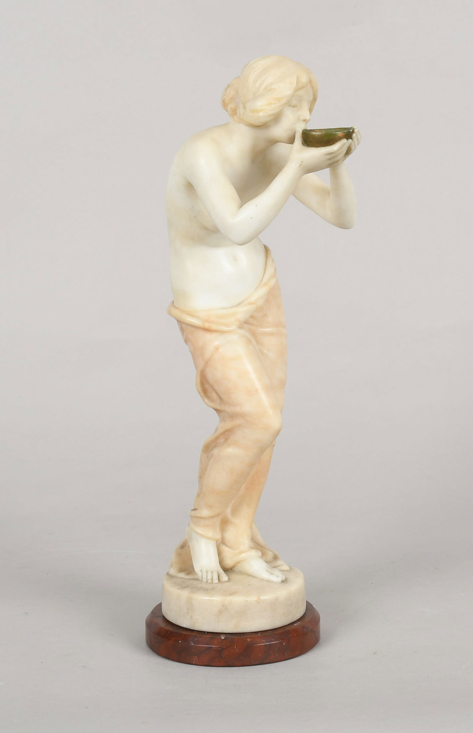 Victor Heinrich Seifert (German, 1870-1953), Woman Drinking from Bowl: Victor Heinrich Seifert (German, 1870-1953), Woman Drinking from Bowl First half of the 20th century, an alabaster carving of a semi-nude woman drinking form a gilt bowl fixed to a marble plint