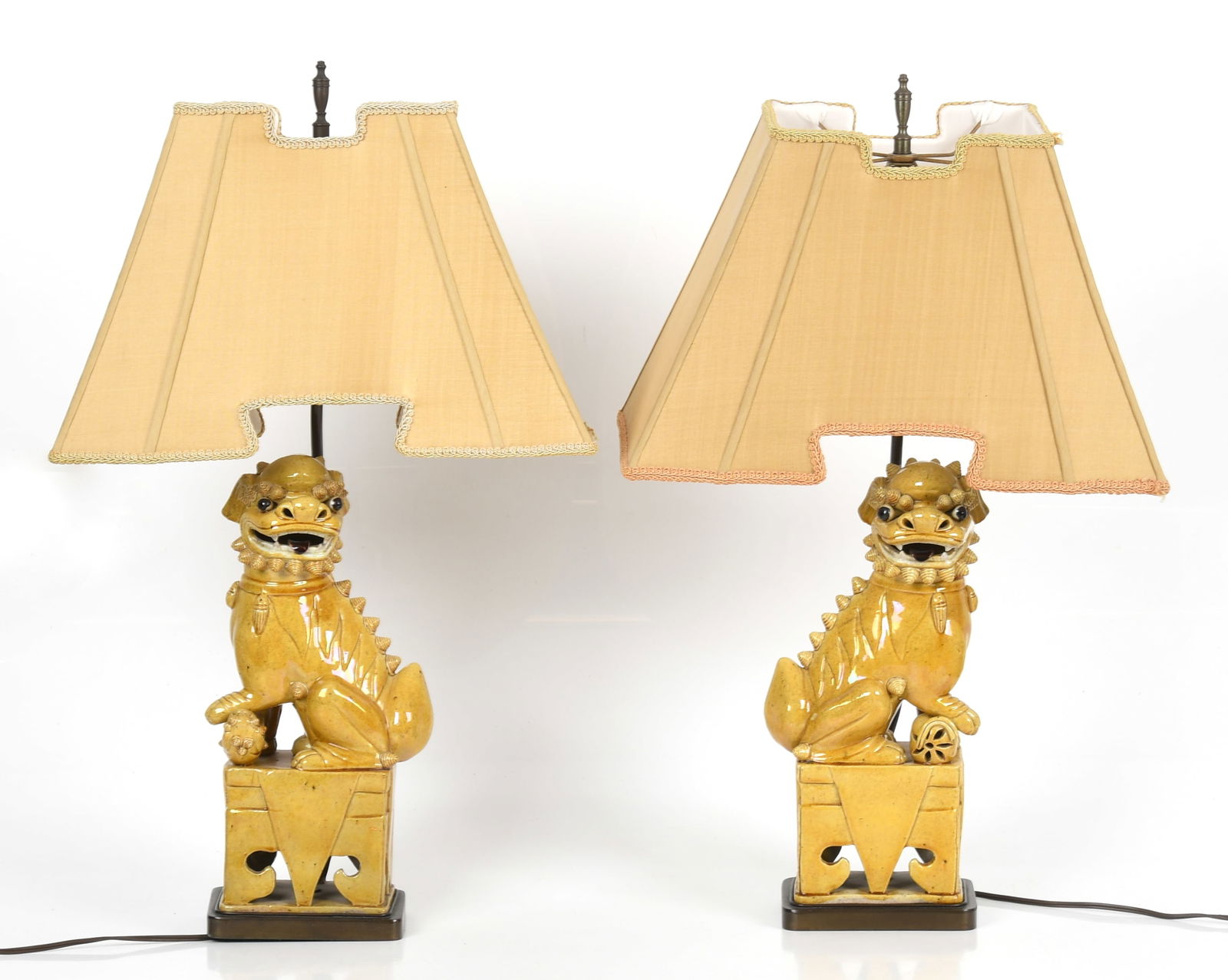 A Pair of Chinese Foo Dogs, Mounted as Lamps: A Pair of Chinese Foo Dogs, Mounted as Lamps A pair of yellow glazed porcelain foo dogs, later mounted as lamps. Each with a high quality custom shade. Dimensions: each foo dog is 5 1/2in x 4in