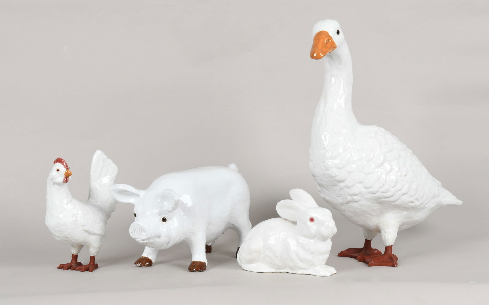 A Group of Four French Bavent-Style Faience Animals, 20th Century: A Group of Four French Bavent-Style Faience Animals, 20th Century All with glass eyes and tin white glaze. Comprising: A standing goose with painted metal feet, a standing pig, 