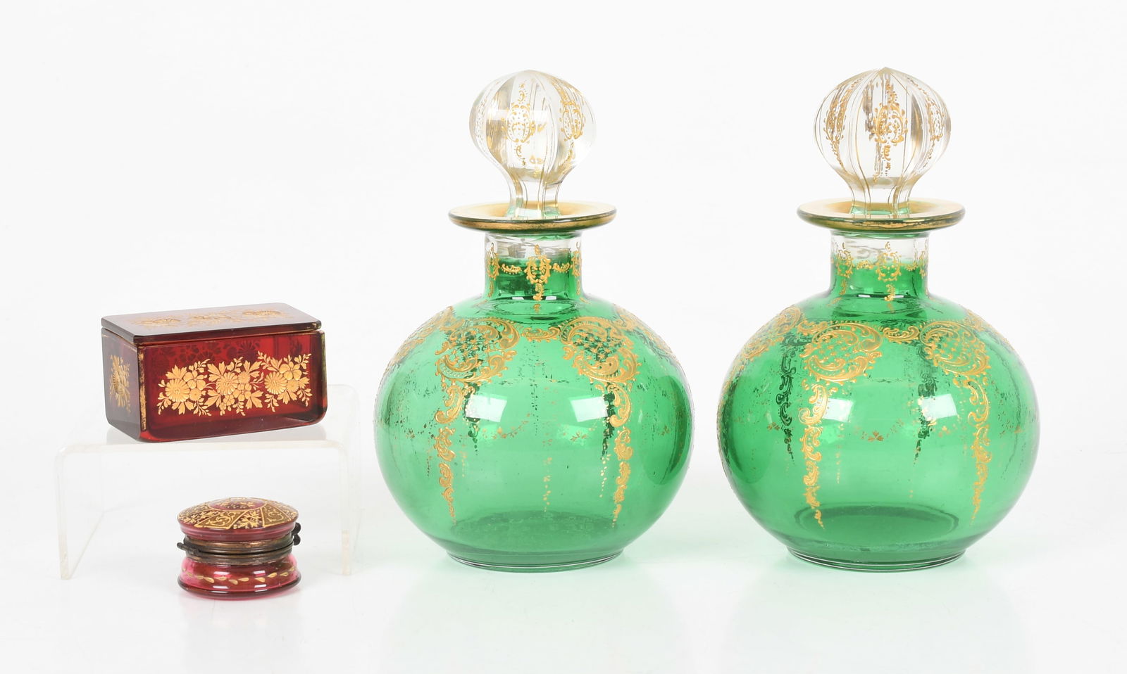 A Pair of Bohemian Glass Scent Bottles and Stoppers, Late 19th/ Early 20th Century: A Pair of Bohemian Glass Scent Bottles and Stoppers, Late 19th/ Early 20th Century With gilt decoration on a green glass ground with clear glass stoppers; together with a small lidded glass box
