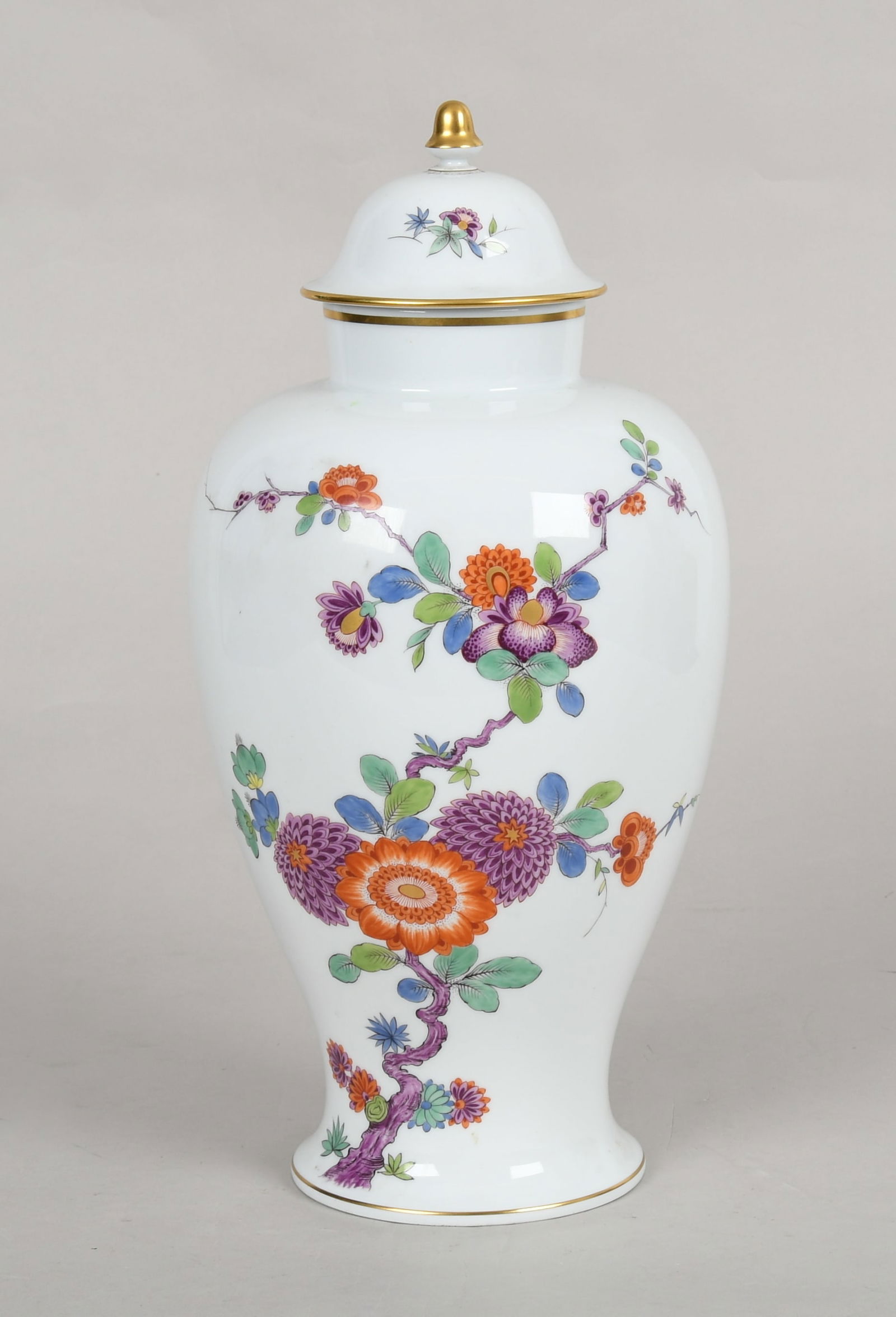 A Meissen Lidded Vase: A Meissen Lidded Vase 20th century, baluster form, model no. 51086, with decoration of various blossoms and an acorn finial. Dimensions: diameter is 7in, the height is 14