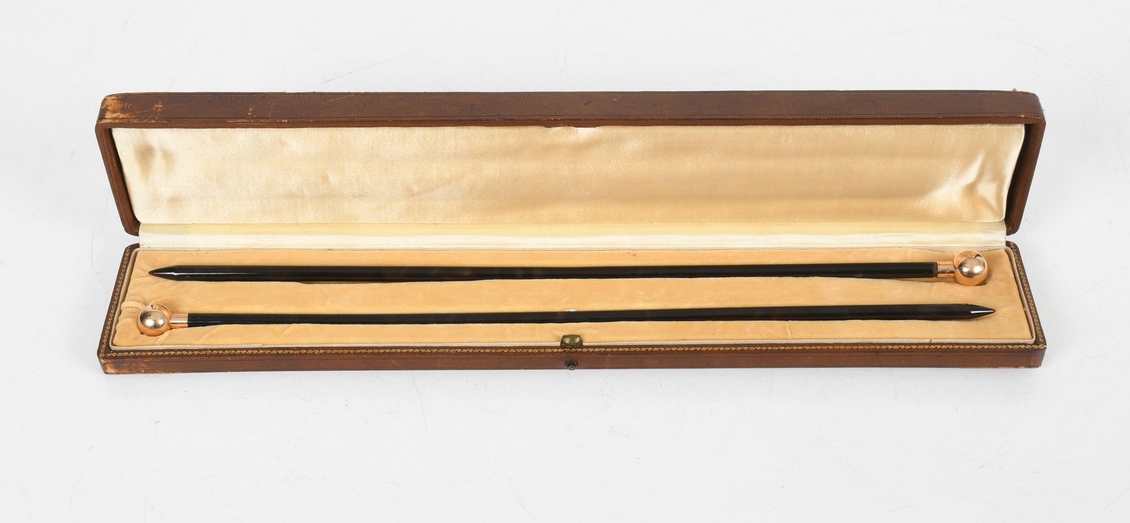 A Pair of Knitting Needles with Gold Terminals: A Pair of Knitting Needles with Gold Terminals A pair of faux tortoiseshell knitting needles with 14k gold (tested) ball terminals and fitted leather case. Each engraved, "M.B. McL.