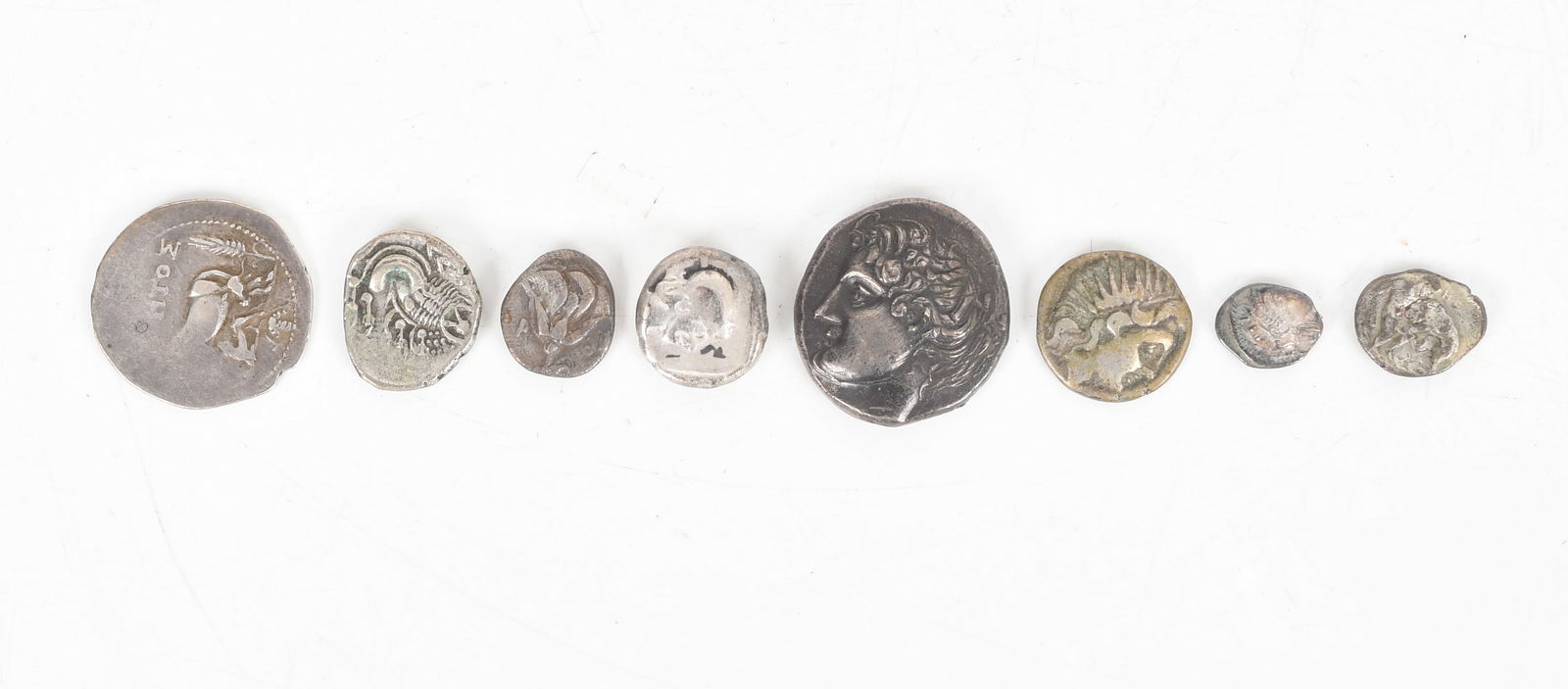 A Group of Ancient Greek and Greek Imitation Silver Coins: A Group of Ancient Greek and Greek Imitation Silver Coins Comprising: an Athens owl Tetradrachm, a Greek cow Dyrrhachium, a coin depicting Heracles fighting a lion, a