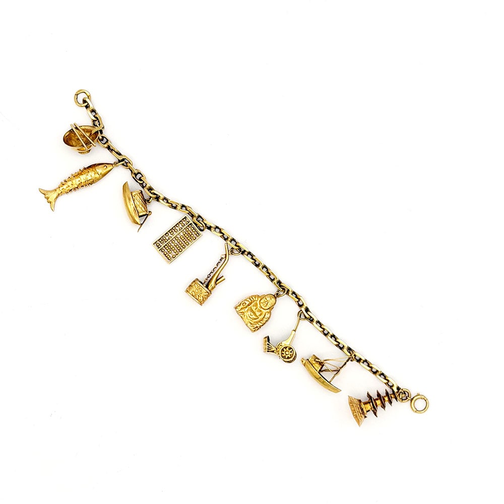 18K Gold Charm Bracelet with Nine 14K charms: 18K Gold Charm Bracelet with Nine 14K charms 18K Yellow gold charm bracelet with nine 14K yellow gold charms with a Chinese charms. Dimensions: Measures 7" long and