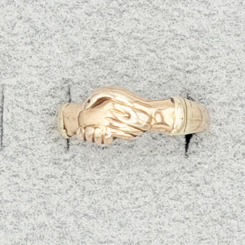 14K Gold 'Holding Hands' Ring: 14K Gold 'Holding Hands' Ring This ring in the form of two hands clasped together. The ring is engraved inside with the initials PFW. Dimensions: The ring is a size 10.5 and