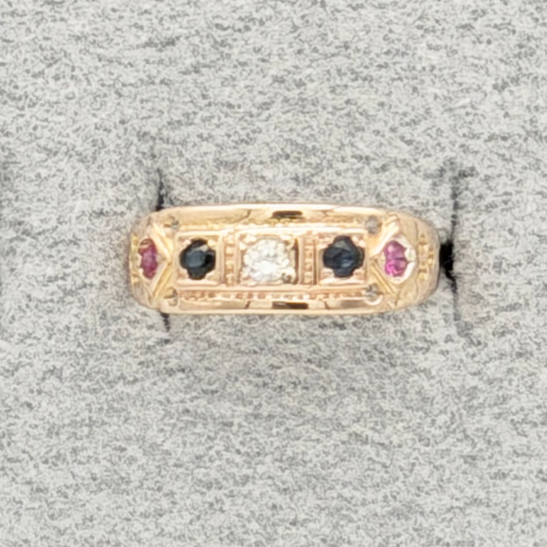 English 15K Ruby Sapphire and Diamond Ring: English 15K Ruby Sapphire and Diamond Ring Antique ring with English hallmarks. The ring is 15ct yellow gold and has a .05pt diamond in the center with ruby and sapphires on either