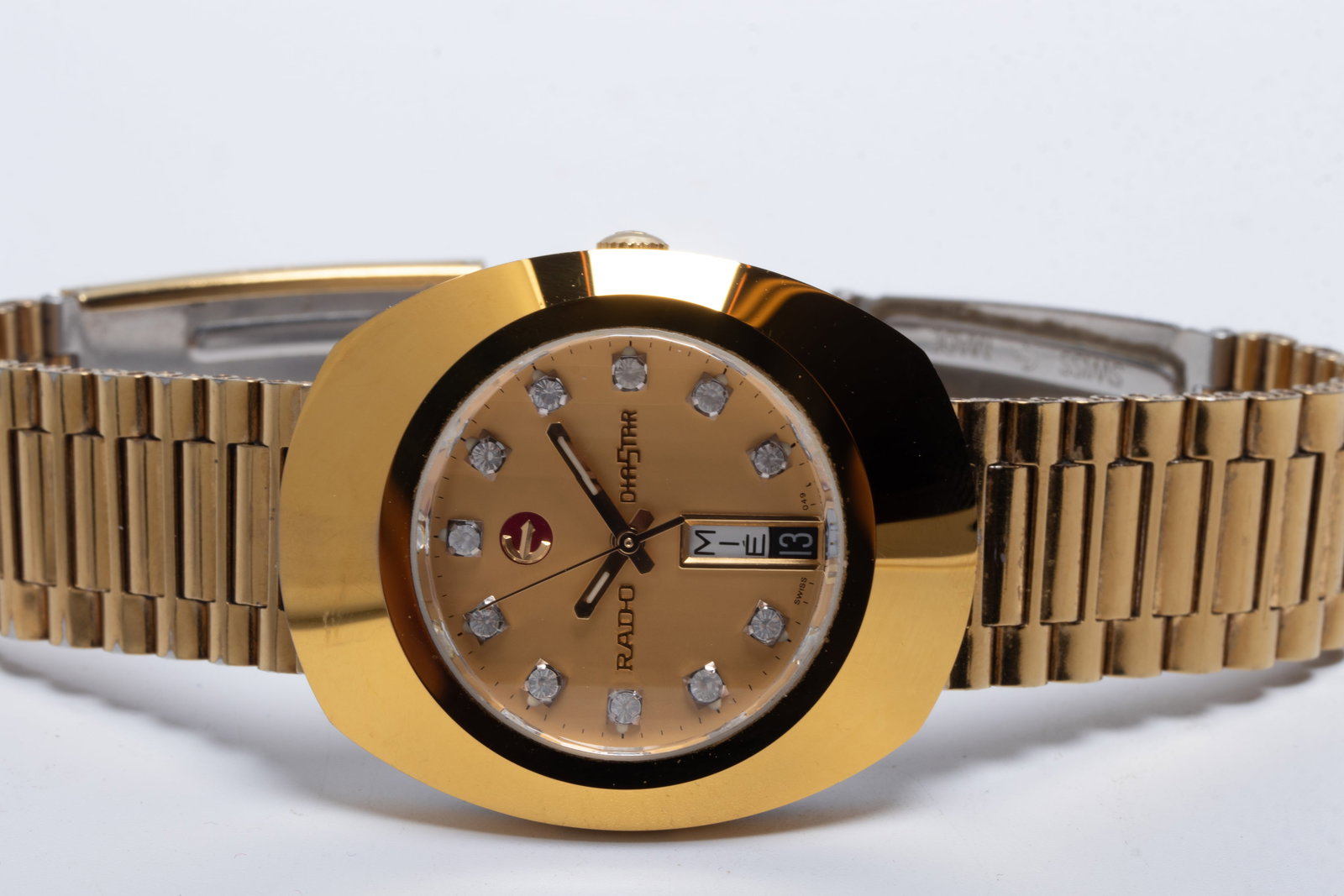 A Rado DiaStar Gold-Tone Wristwatch: A Rado DiaStar Gold-Tone Wristwatch Circa 1990's, ref. 636.0313.3 an automatic wristwatch with day-date function housed in a tungsten-carbide "SCRATCHPROOF" stainless steel g