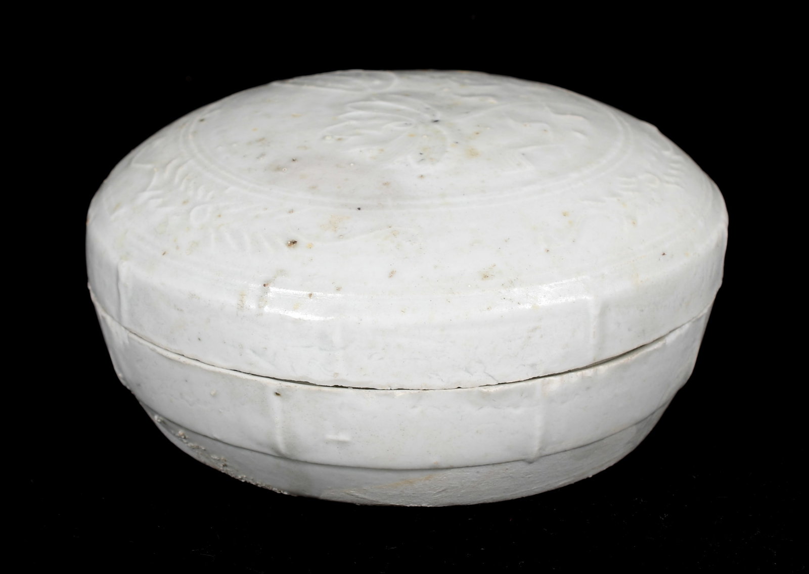 A Chinese White Glazed Porcelain Box, Song Dynasty: A Chinese White Glazed Porcelain Box, Song Dynasty Circular with lotus and foliate decoration. Dimensions: 4 1/2in diameter, the height is 1 3/4in. &nb