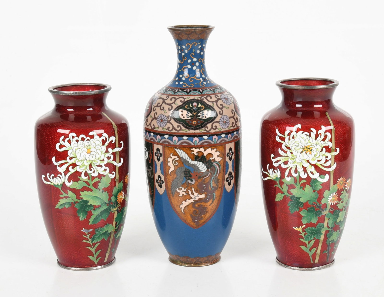 Three Japanese Cloisonne Vases: Three Japanese Cloisonne Vases Meiji-Taisho period, comprising: a pair of red Ginbari vases decorated with shaded flowers and bamboo, and a blue vase with banners of dragons and