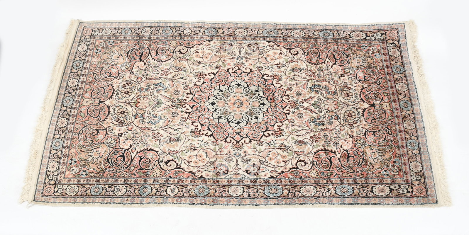 A Modern Silk Blend Hand Knotted Persian Rug: A Modern Silk Blend Hand Knotted Persian Rug 20th century, with a cream ground, floral border and central medallion. Dimensions: 89 x 48in 