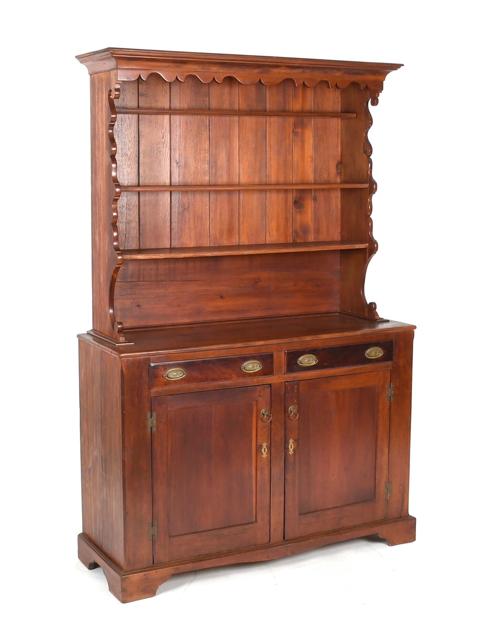 A Pennsylvania Step-Back Cupboard, 19th Century: A Pennsylvania Step-Back Cupboard, 19th Century In two parts; the upper portion open, with shaped sides and three shelves with plate groves, the lower portion with two short drawers above a