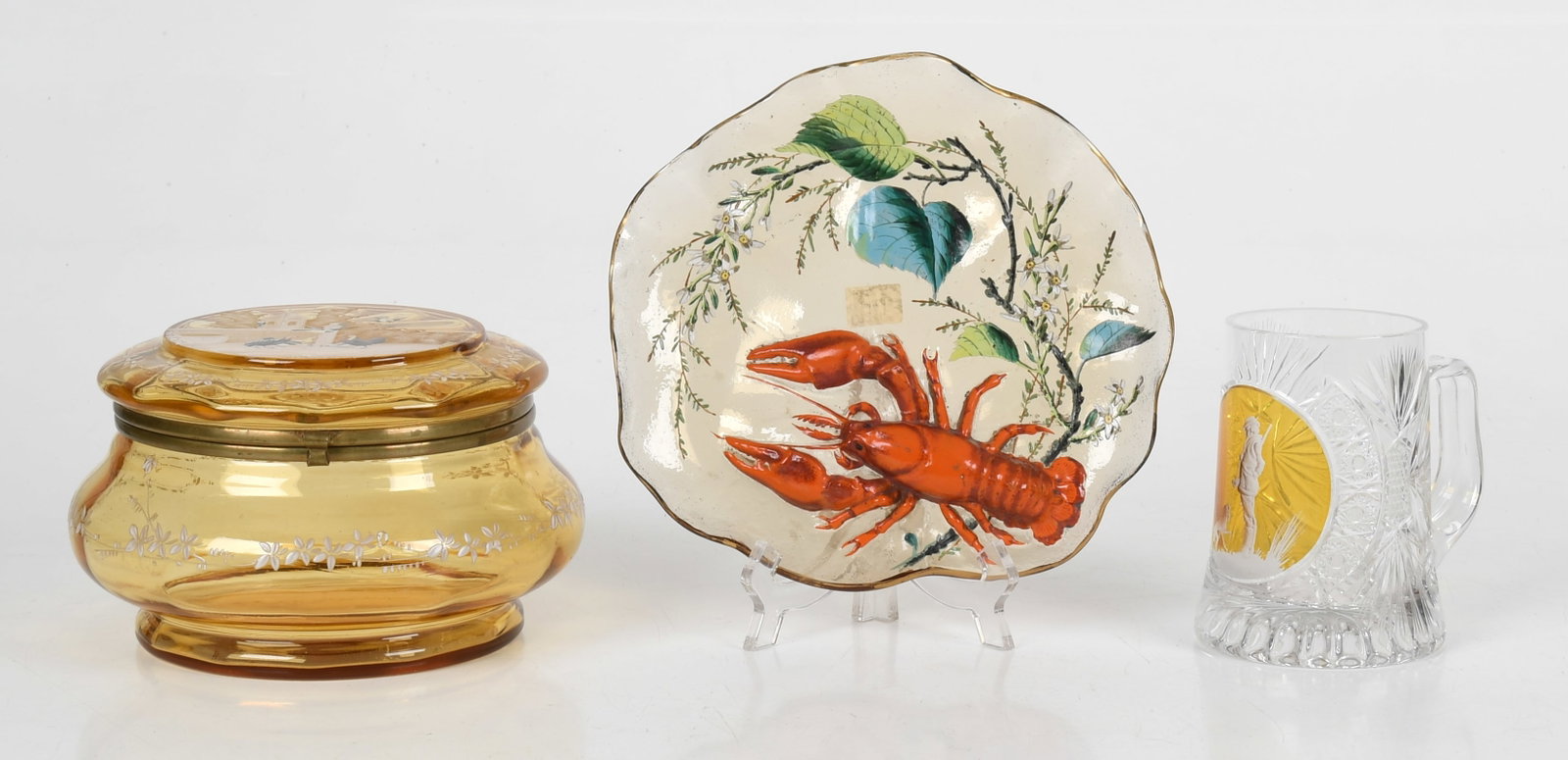 Three Pieces of European Art Glass: Three Pieces of European Art Glass Early 20th century, comprising: A brilliant cut and cut-to-clear mug depicting a hunter and dog in profile by Goda Hungary, a Palissy style enameled