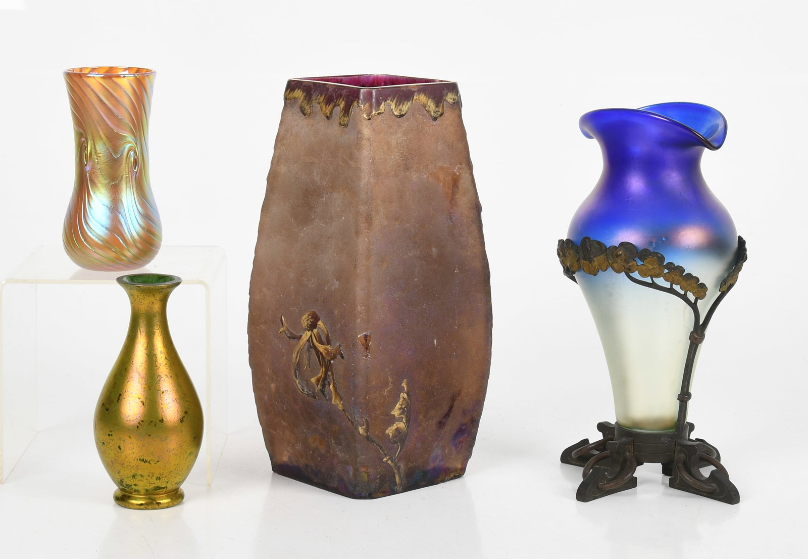 Four Art Glass Vases: Four Art Glass Vases Early 20th century, comprising: a 9 3/4in tall Daum style hand painted and etched vase with parcel gilt flowers, two approximately 5 1/4in luster finished small vases,
