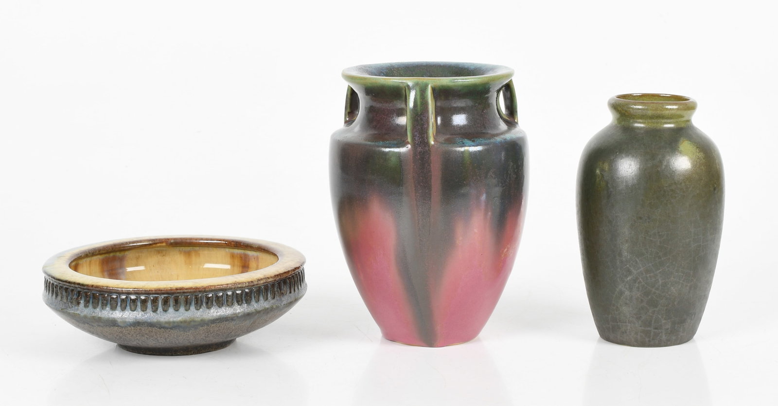 Three Fulper Pottery (Flemington, New Jersey, 1814-1930) Vessels, c. 1920-1930: Three Fulper Pottery (Flemington, New Jersey, 1814-1930) Vessels, c. 1920-1930 Comprising: a three-handled vase with flambe glaze decoration; a mottled matte green-glazed vase; and a shallow bo