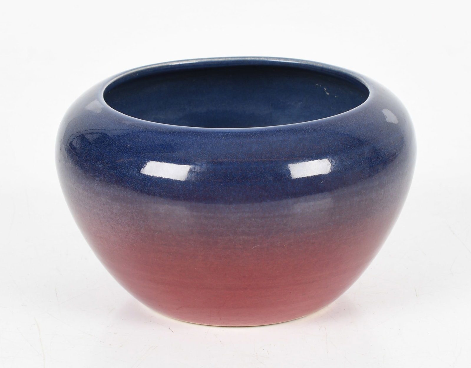 A North Dakota School of Mines Pottery Bowl: A North Dakota School of Mines Pottery Bowl With a purple shaded to red glaze, marked as pictured. Dimensions: 5in diameter, the height is 3 1/2in. &nb