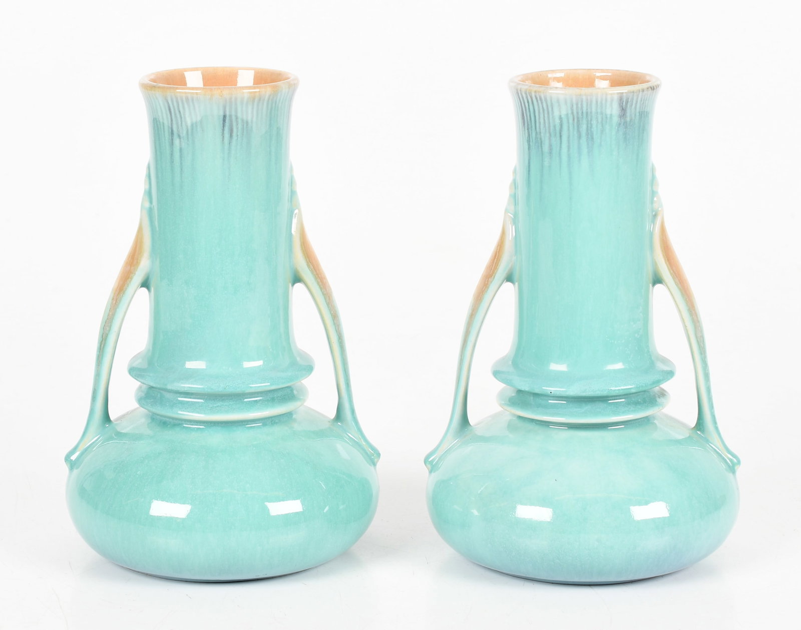A Pair of Roseville Orian Vases: A Pair of Roseville Orian Vases Circa 1930's, shape no. 735, in a light green glaze, both retaining silver Roseville foil labels. Dimensions: each is 7 1/