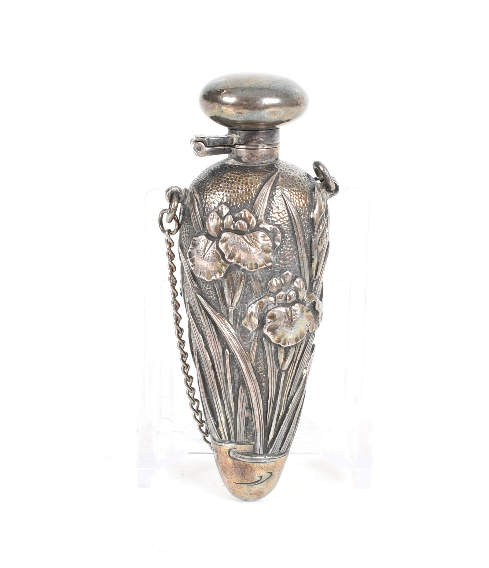 An Art Nouveau Period Silver Scent Bottle: An Art Nouveau Period Silver Scent Bottle A tear drop form example with iris decoration in low relief. Unmarked, but tested as silver. Dimensions: 3in long, the approximate