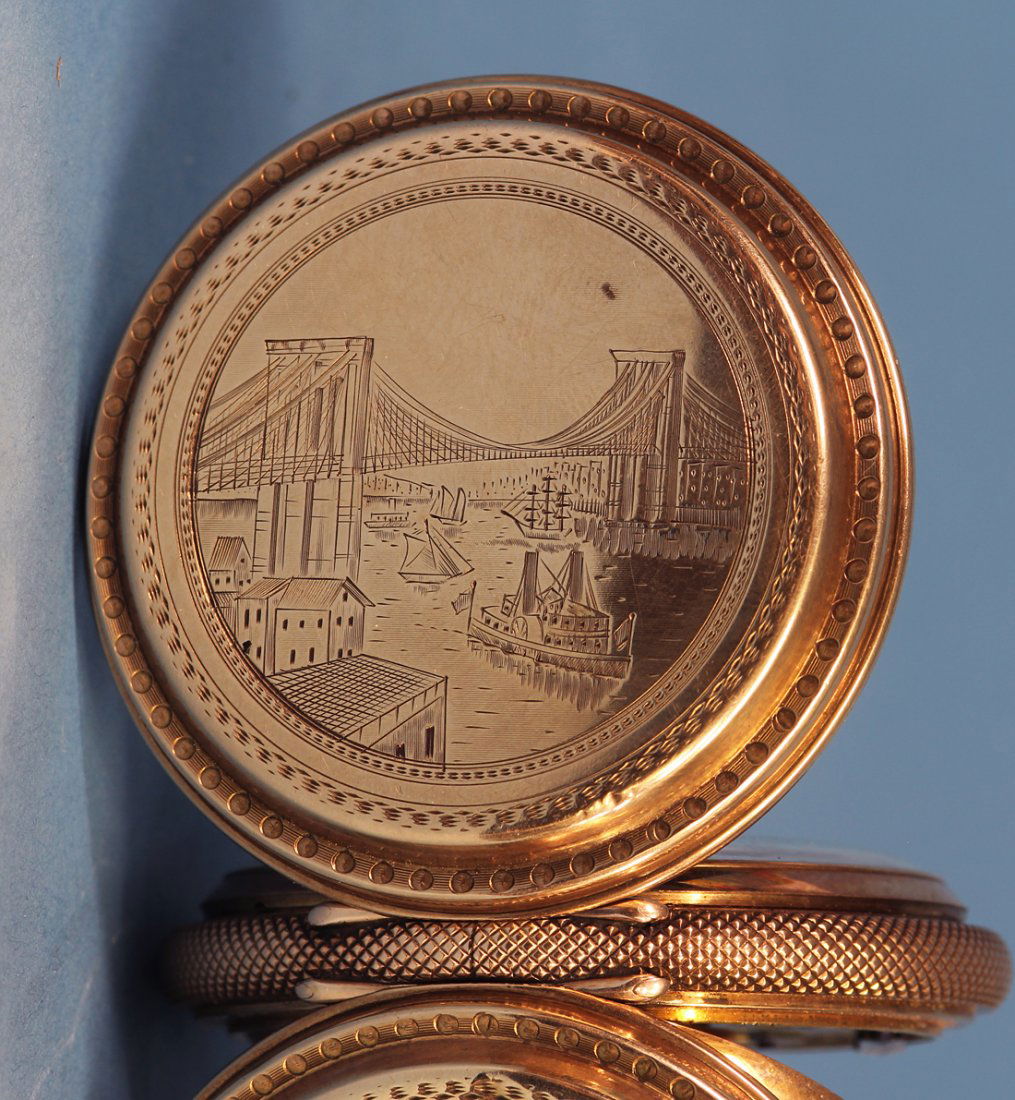 Rare Gold Pocket Watch Celebrating Brooklyn Bridge: 18k engraved hunter case with Elgin watch movement. Case carries stamp of Brooklyn Watch Case Company. '18' and '279401'. Engraved front is copy of 1883 Lithograph by Currier and Ives - 'The Great Eas