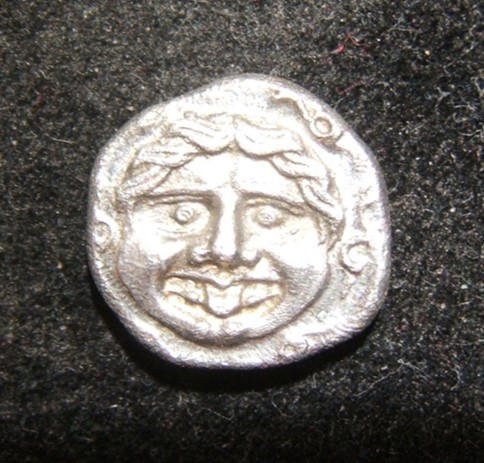 Greek Parion Hemidrachm Gorgoneion head ancient coin,: Ancient Greece > Parion: Hemidrachm (13.5 x 13mm, 2.25g), 350-300 BCE; head of Gorgoneion facing, sticking tongue out (not snake), no crown on head / bull standing to left with head reverted right, st