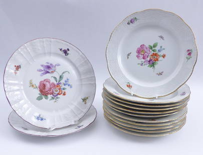 13 Speiseteller mit Blumenmalerei â€” Berlin, fr. 20.: 13 Dinner plate with flower painting / â€” Berlin, early 20th century / Eleven with ornamental relief and gold edge, two with ''Rocaille'' relief and purple edge. Porcelain with polychrome