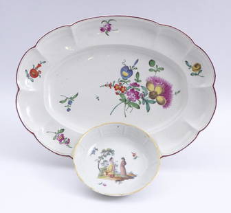 Platte und Untertasse â€” Ludwigsburg, 18. Jh.: Plate and Saucer / â€” Ludwigsburg, 18th century / Oval plate, the lip with pleats and curved margins, painted with a large bouquet of flowers and small flower twigs; l. 34,3 cm. Saucer with