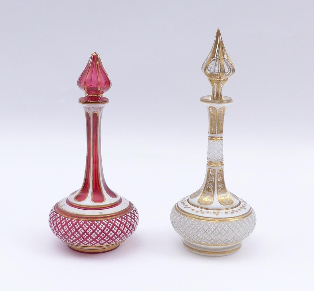 Paar Flakons : Boehmen, M. 19. Jh. :: Pair of flasks : Bohemia, mid 19th c. Colorless and rosalin underlaid glass with cut pewter enamel overlay. Floral and geometrical decor. H. 21 cm. - Gold rubbed in places; one stopper broken off at t