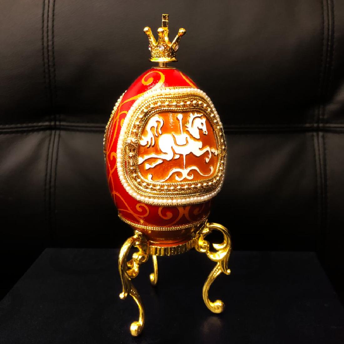 Faberge Merry Go Round Egg A Great Mantle Piece: A Merry Go Round Faberge Egg In Navy Box. This Display Piece Winds Up And the Merry Go Round Rotates To The Music. Doctorate Front and Rear Door That Opens To Display The Revolving Horses Inside.