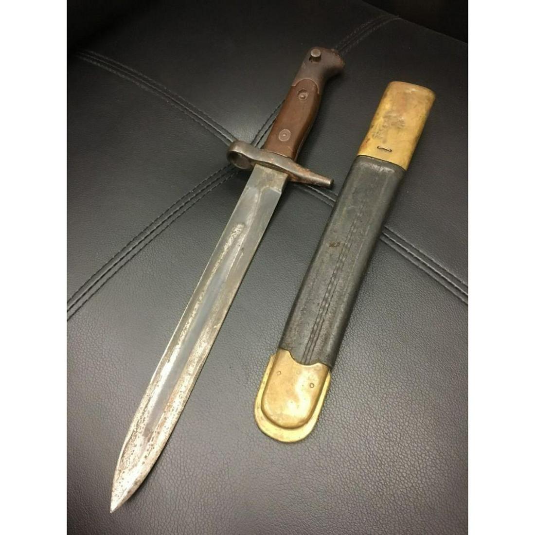 Authentic WWI German Bayonet with Scabbard: WWI German Bayonet with Scabbard This is good solid WWI German Bayonet with scabbard. The grips are in overall condition and are made from wood. The fittings are untouched and exhibit a nice age patin