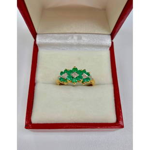 Detailed Ladies Size 7, 10k Gold, Emerald and Diamond: This ring is completed with seven 0.04ct round cut emerald stones, and is mediated by four small, round cut diamonds. All set in a lustrousÂ 10k gold ring. Please view photos for further