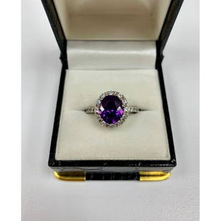 Brilliant Ladies size 6 Amethyst, Sterling Silver Ring: This ring contains a perfectly cut oval Amethyst stone, and is surrounded by small, round cut crystals. All set in a Victorian style 925 sterling silver ring. Please view photos for further