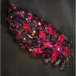 Contemporary violet rhinestone brooch with flower: Contemporary violet rhinestone brooch with flower motif.