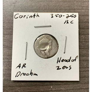 350-250 B.C. Corinth Head of Zeus Silver Drachm: A 350-250 B.C. Corinth Head of Zeus Silver Drachm. Has a peculiarÂ punch mark on the obverse side of the coin, possibly a special mark left by the smith. Please view photos for further details.Â