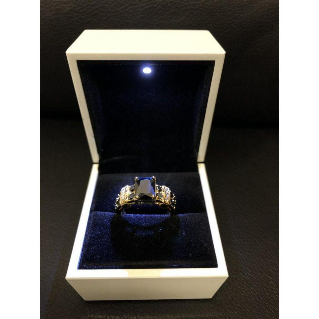 Ladies Black Sapphire 6ct Main Stone Marked 10kt Ring: A Black Sapphire 6ct Main Stone Marked 10kt Ladies Ring. Comes in White Enameled LED Ring Box. View Photos For Details.