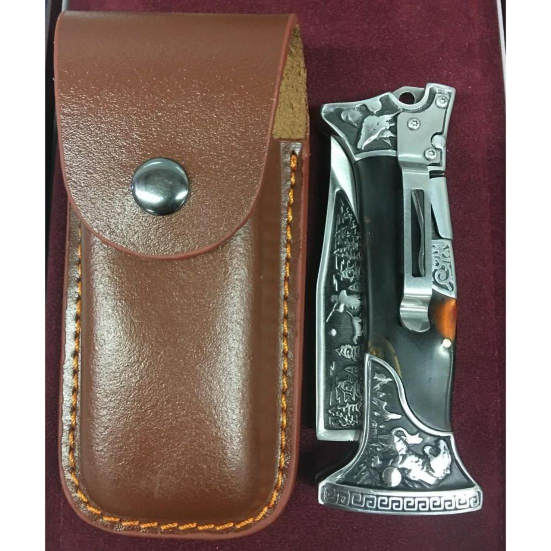 Solid Steel Folding Hunting Knife With Leather Sheath: A Solid Steel Folding Hunting Knife With Leather Sheath. Knife Is Decorated With A Hunting Scene On The Blade, Deer and Cougar On The Handle. A Quick Release Button To Unlock The Blade. Knife Is 9" In